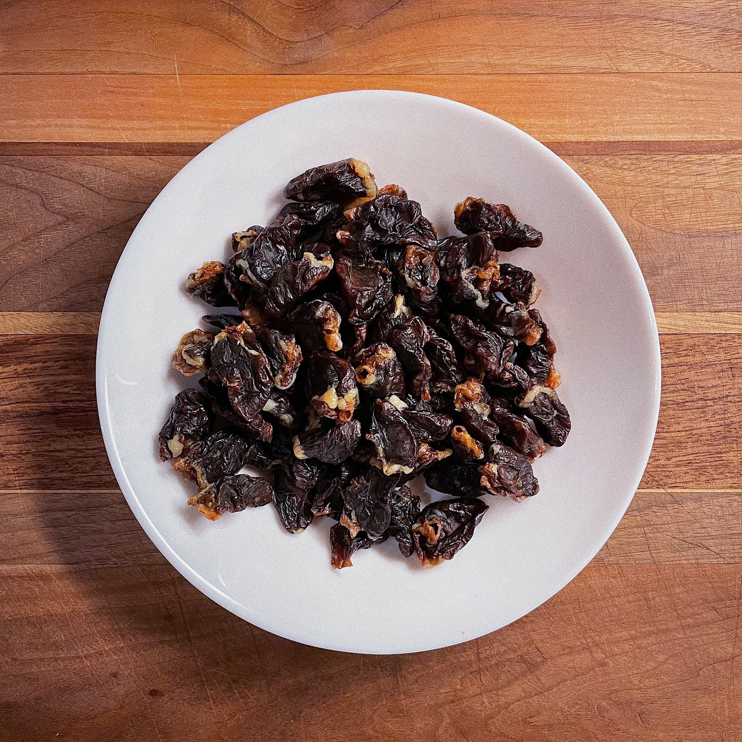 Natural, high quality, handmade, quarter sized chicken hearts in a plate.