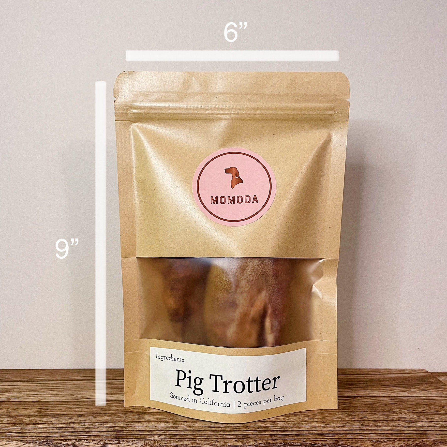 A packaged pig trotter in an eco friendly kraft zipper bag. The measurment shows the bag is 6" by 9".