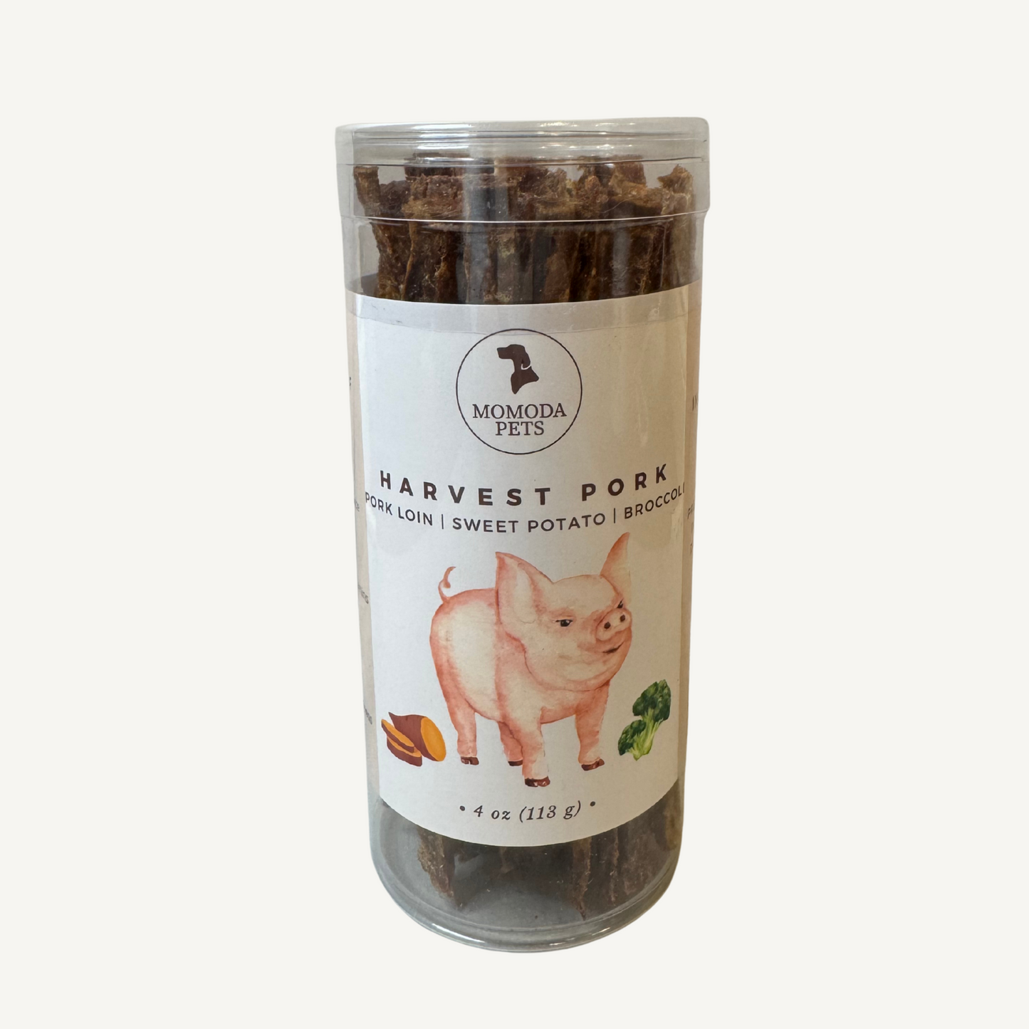 Tube of 'Harvest Pork' pet treats with a label on a white background